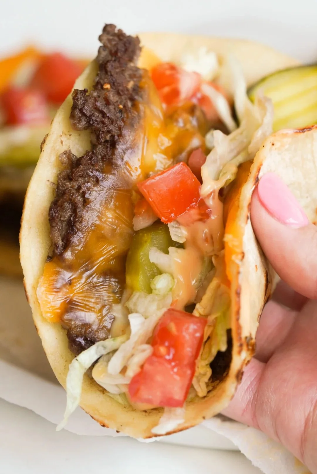 Big Mac Smash Burger Tacos served on a plate with fresh ingredients.