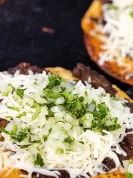 Delicious Birria-style Smash Tacos, loaded with flavors and served with consommé.