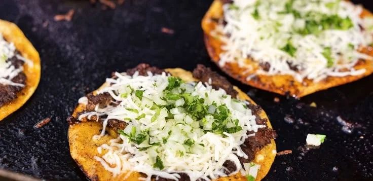 Delicious Birria-style Smash Tacos, loaded with flavors and served with consommé.