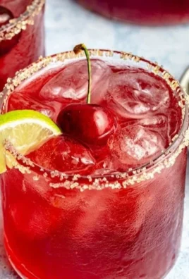 Delicious Cherry Limeade Cocktail with fresh cherries and lime slices