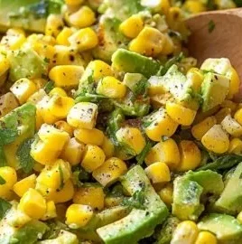 Fresh Corn Avocado Salad with vibrant vegetables and dressing in a bowl