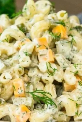 Delicious dill pickle pasta salad served in a bowl with fresh ingredients