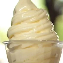 Delicious homemade Pineapple Dole Whip in a bowl with a pineapple slice