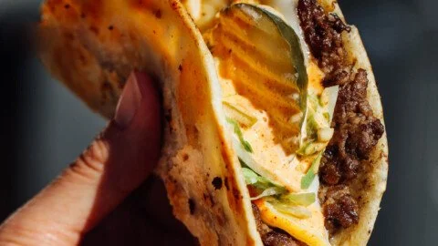Delicious easy smash burger tacos served on a plate with toppings