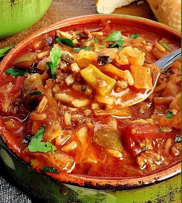 Bowl of easy stuffed cabbage soup garnished with fresh herbs