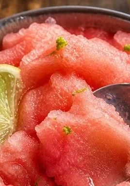 Refreshing frozen watermelon lime slush drink in a glass