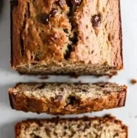 Slice of Greek Yogurt Banana Bread on a wooden table.