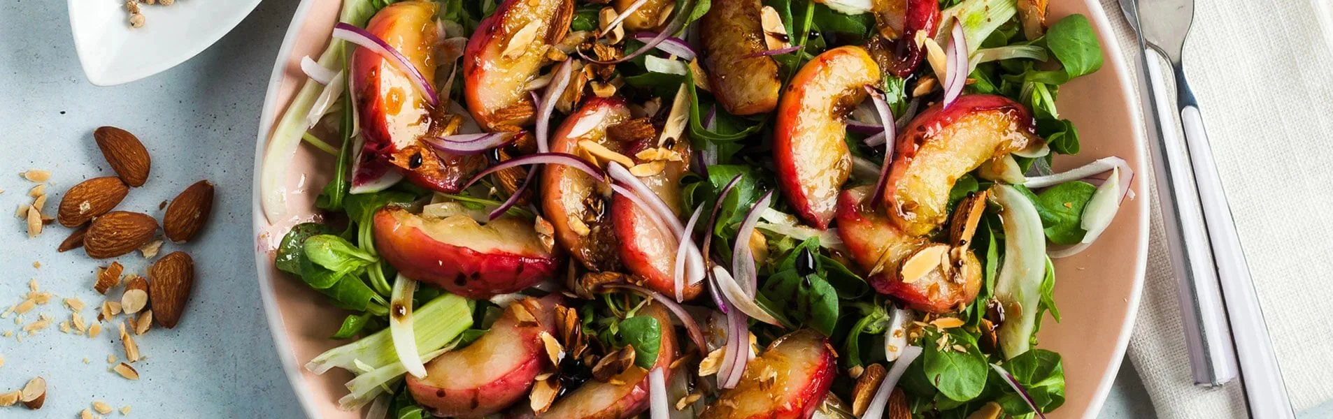 Delicious grilled peach salad featuring summer fruits and greens