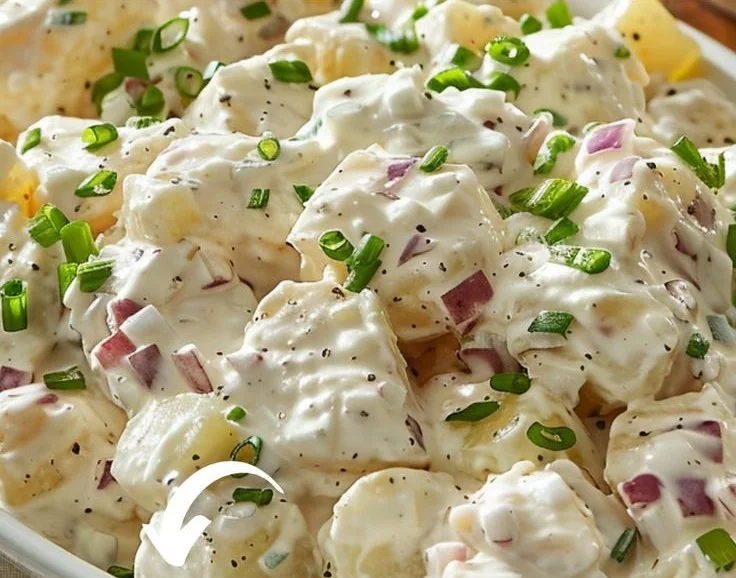 Delicious bowl of Hellmann’s Potato Salad garnished with herbs