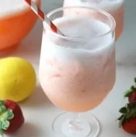 Refreshing homemade strawberry lemonade in a glass with fresh strawberries