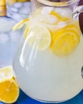 Glass of refreshing lemonade with slices of lemon and mint garnish