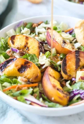 Maple bourbon grilled peach salad with fresh greens and walnuts