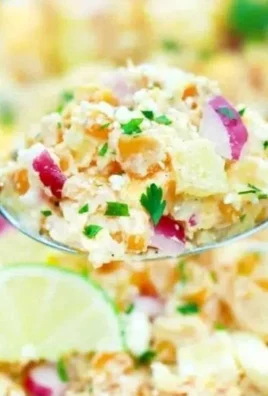 Bowl of Mexican street corn potato salad with fresh ingredients and seasoning