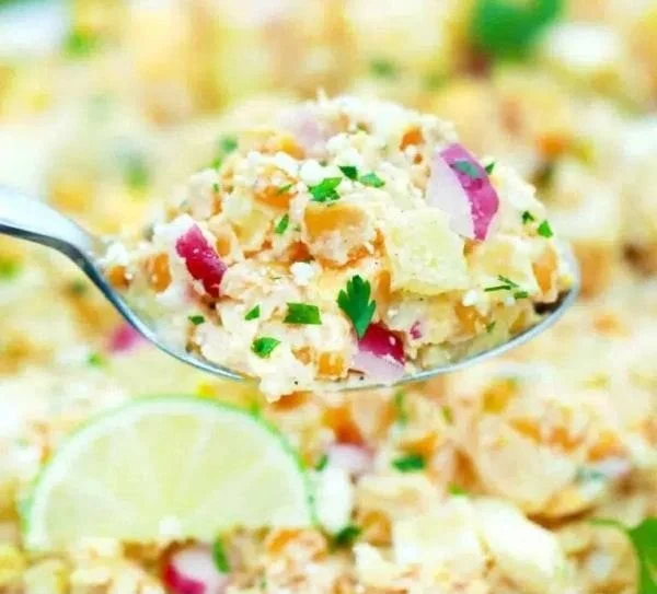 Bowl of Mexican street corn potato salad with fresh ingredients and seasoning