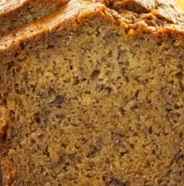 Moist banana bread freshly baked and served on a wooden table