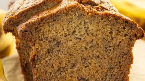 Moist banana bread freshly baked and served on a wooden table