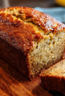 Delicious slice of Old Fashioned Banana Bread on a wooden table