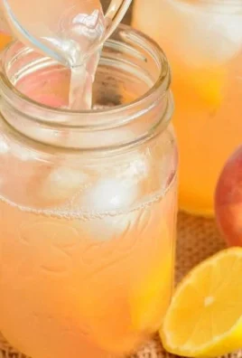 A refreshing glass of peach lemonade on a sunny day.