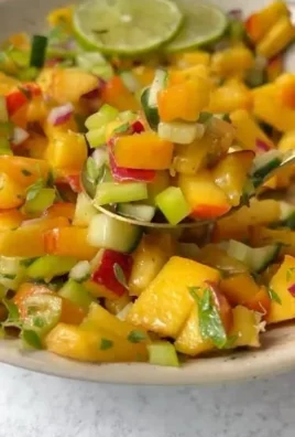Fresh peach salsa with diced peaches and vegetables in a bowl