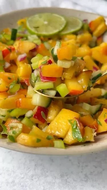 Fresh peach salsa with diced peaches and vegetables in a bowl
