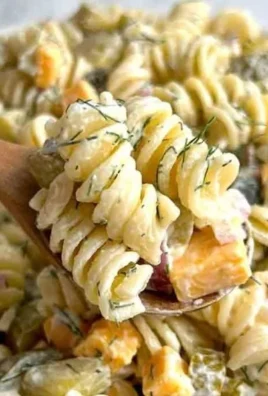 Quick and easy dill pickle pasta salad served in a bowl with fresh ingredients.
