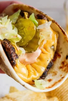 Delicious smash burger taco topped with homemade burger sauce.