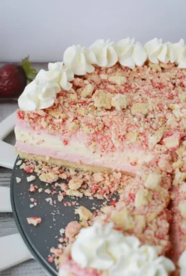 Delicious Strawberry Crunch Cheesecake topped with fresh strawberries and crunchy bits