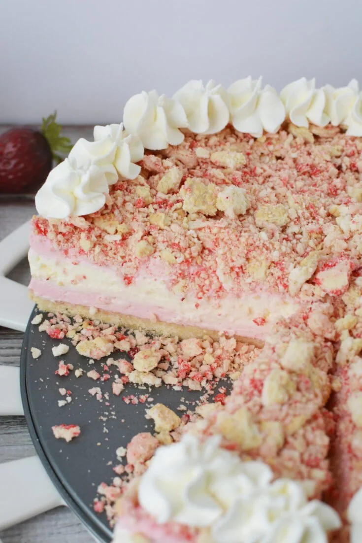 Delicious Strawberry Crunch Cheesecake topped with fresh strawberries and crunchy bits