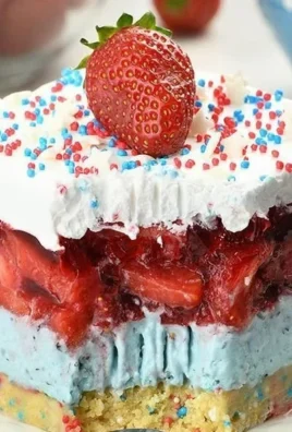 Delicious Summer Berry Jello Lasagna with layers of colorful fruits and gelatine