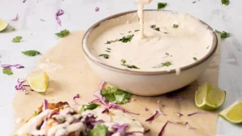 Baja Sauce drizzled over tacos for a zesty flavor