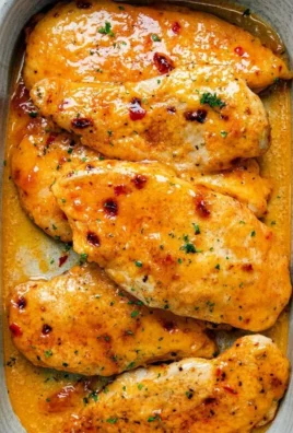 Delicious Bang Bang Chicken Bake ready to serve, topped with creamy sauce.
