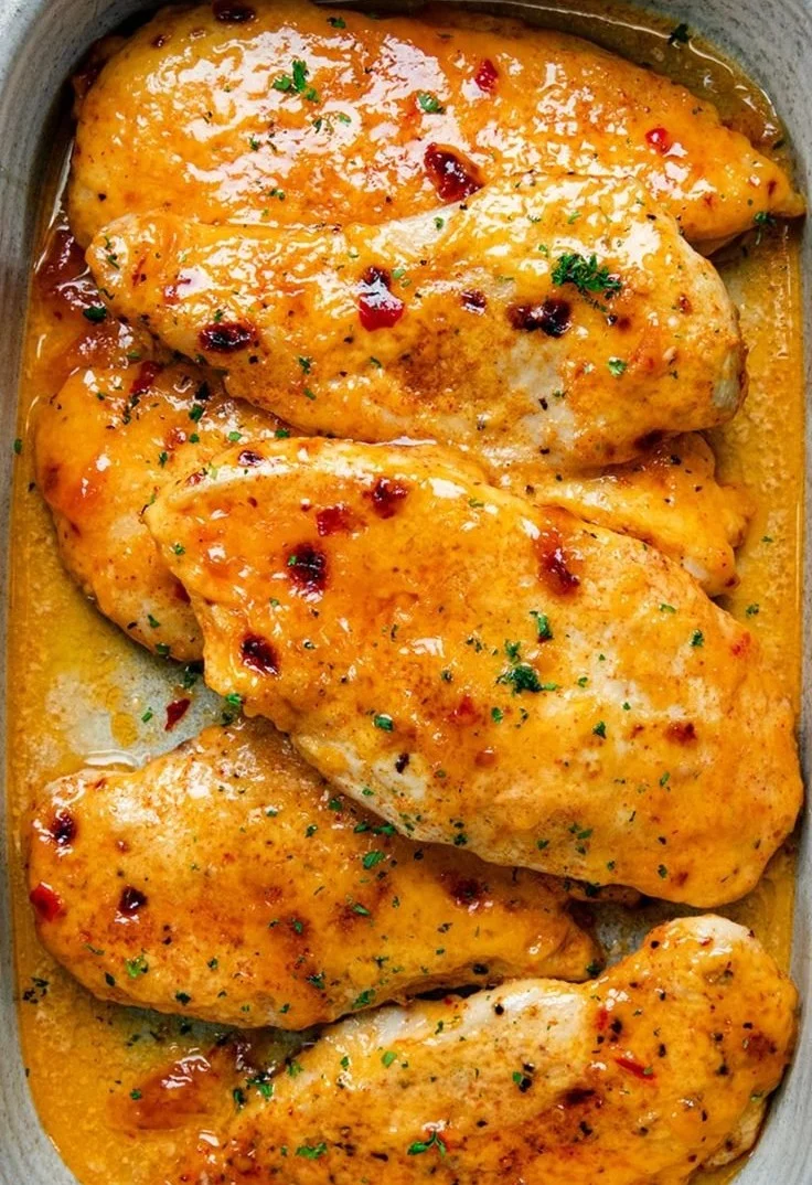 Delicious Bang Bang Chicken Bake ready to serve, topped with creamy sauce.