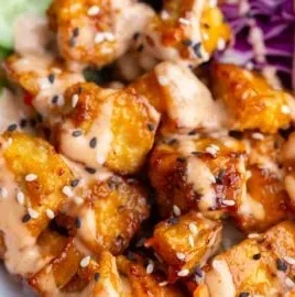Crispy Bang Bang Tofu prepared in an air fryer and served plated.