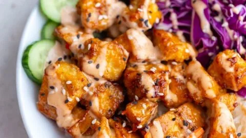 Crispy Bang Bang Tofu prepared in an air fryer and served plated.