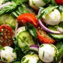 Fresh basil salad with colorful vegetables and a drizzle of dressing