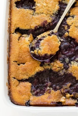 Delicious homemade blueberry cobbler with crispy topping and fresh blueberries