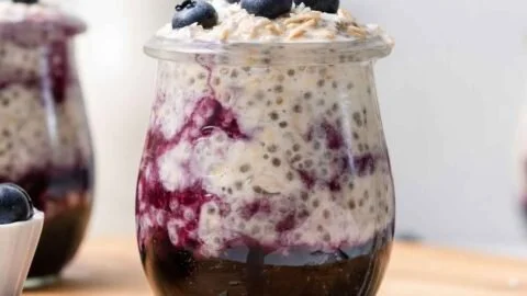 Bowl of creamy blueberry overnight oats topped with fresh blueberries and almonds