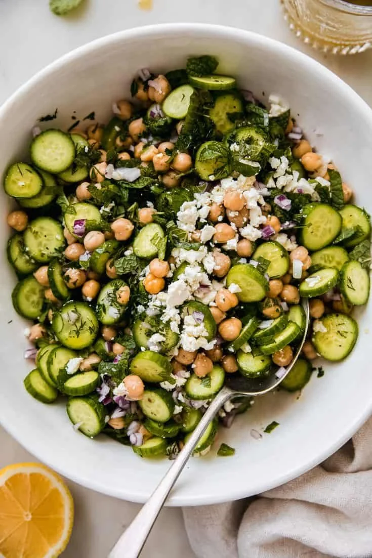 Bright cucumber chickpea salad with feta cheese and fresh vegetables.