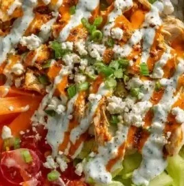 Buffalo Chicken Protein Bowl topped with fresh ingredients and spicy sauce