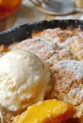 Bowl of Classic Southern Peach Cobbler with fresh peaches and golden crust