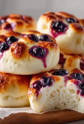 Cottage Cheese Blueberry Cloud Bread served on a wooden plate.