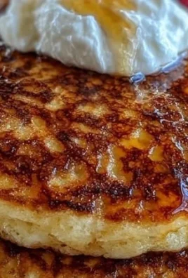 Delicious homemade cottage cheese pancakes served with syrup and fruits