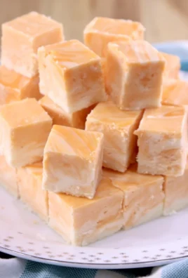 Delicious Creamsicle Fudge featuring orange and vanilla flavors in a creamy texture.