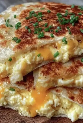 Crispy egg and cheese breakfast quesadillas served on a plate.