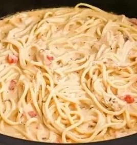 Crock Pot Cheesy Chicken Spaghetti served in a bowl with cheese and herbs