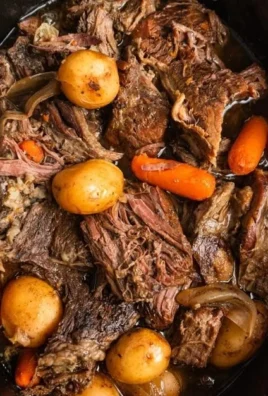 Crock Pot chuck roast cooked to perfection with vegetables and herbs.