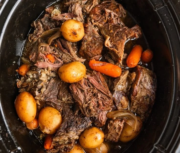Crock Pot chuck roast cooked to perfection with vegetables and herbs.