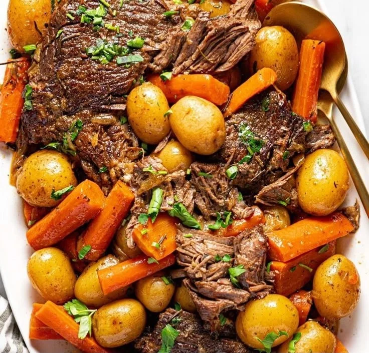 Crock pot pot roast with vegetables and herbs in a slow cooker