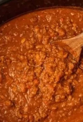 Crock Pot Pumpkin Chili in a bowl topped with fresh herbs and spices