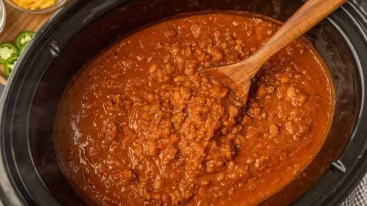Crock Pot Pumpkin Chili in a bowl topped with fresh herbs and spices